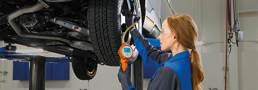 A Subaru technician checking tire pressure. | Puente Hills Subaru in City of Industry CA