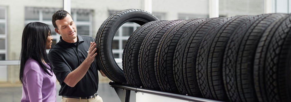 Subaru service representative showing customer a tire. | Puente Hills Subaru in City of Industry CA